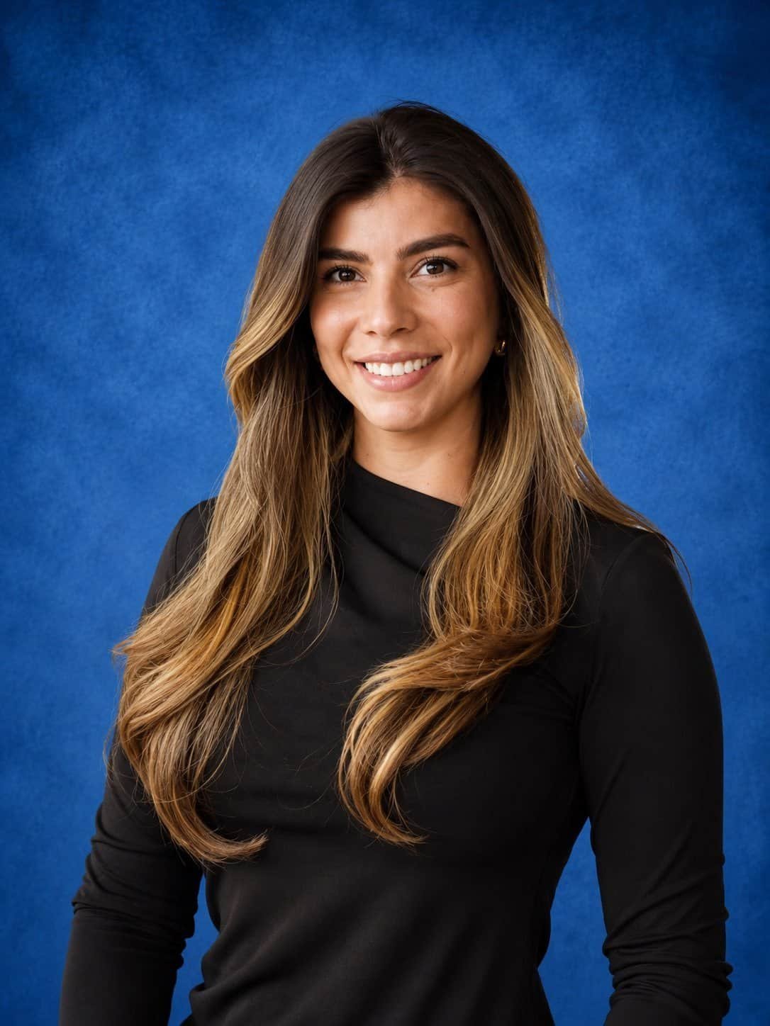 Professional woman smiling for the camera in a black top.