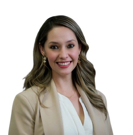 Professional portrait of a smiling woman with long brown hair in a cream blazer, white background.